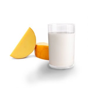 Small wheel of cheese and glass of milk